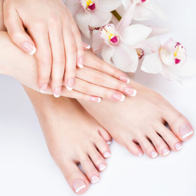 female feet at spa salon on pedicure and manicure procedure Closeup photo of a female feet at spa salon on pedicure and manicure procedure - Soft focus image